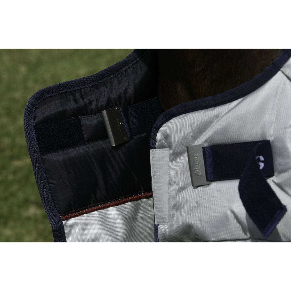 Close up of opened Bucas "clickgo" fastener, with metal clip, velcro and blue strap.