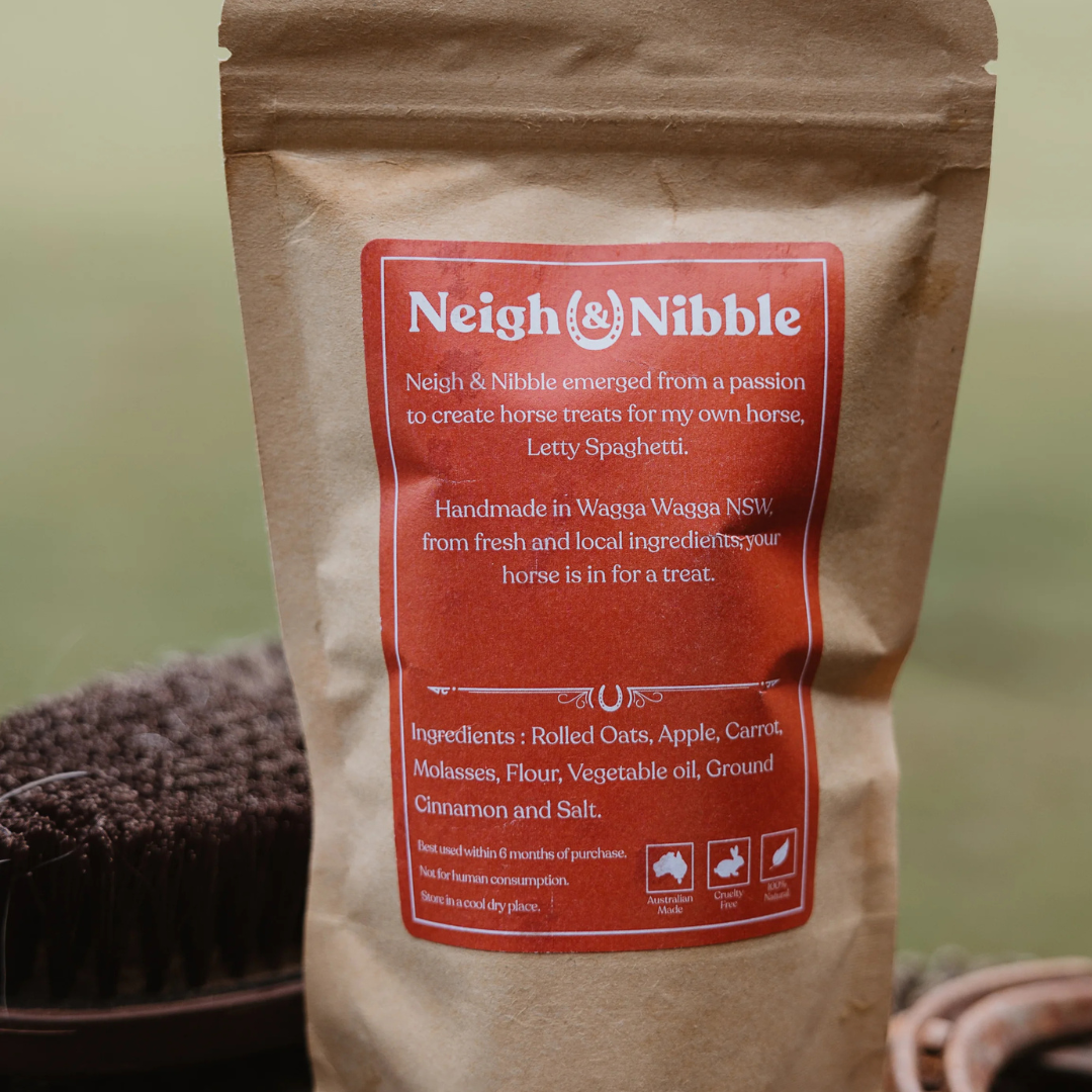 A paper pouch of Neigh & Nibble Natural horse treats, labeled 'Apple & Carrot Spaghettis Confetti'