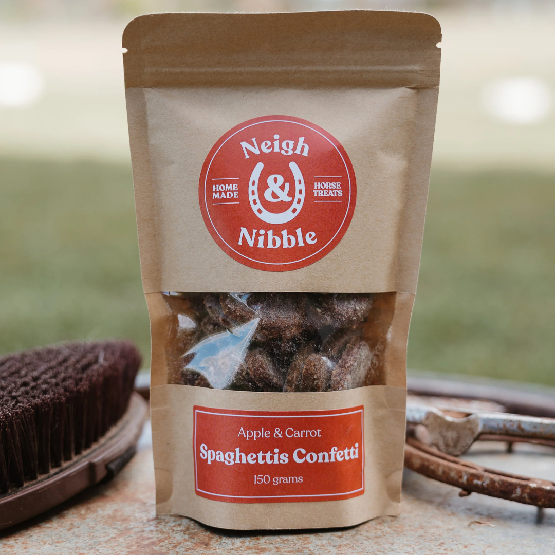 A paper pouch of Neigh & Nibble Natural horse treats, labeled 'Apple & Carrot Spaghettis Confetti'