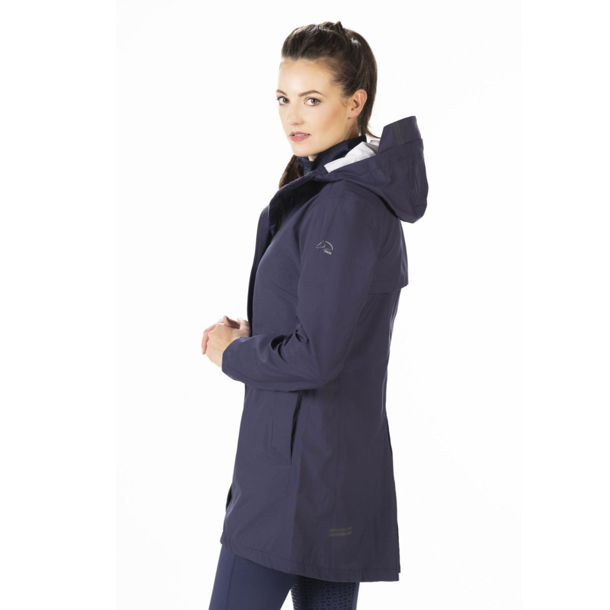 View from the side of girl wearing weatherproof raincoat.